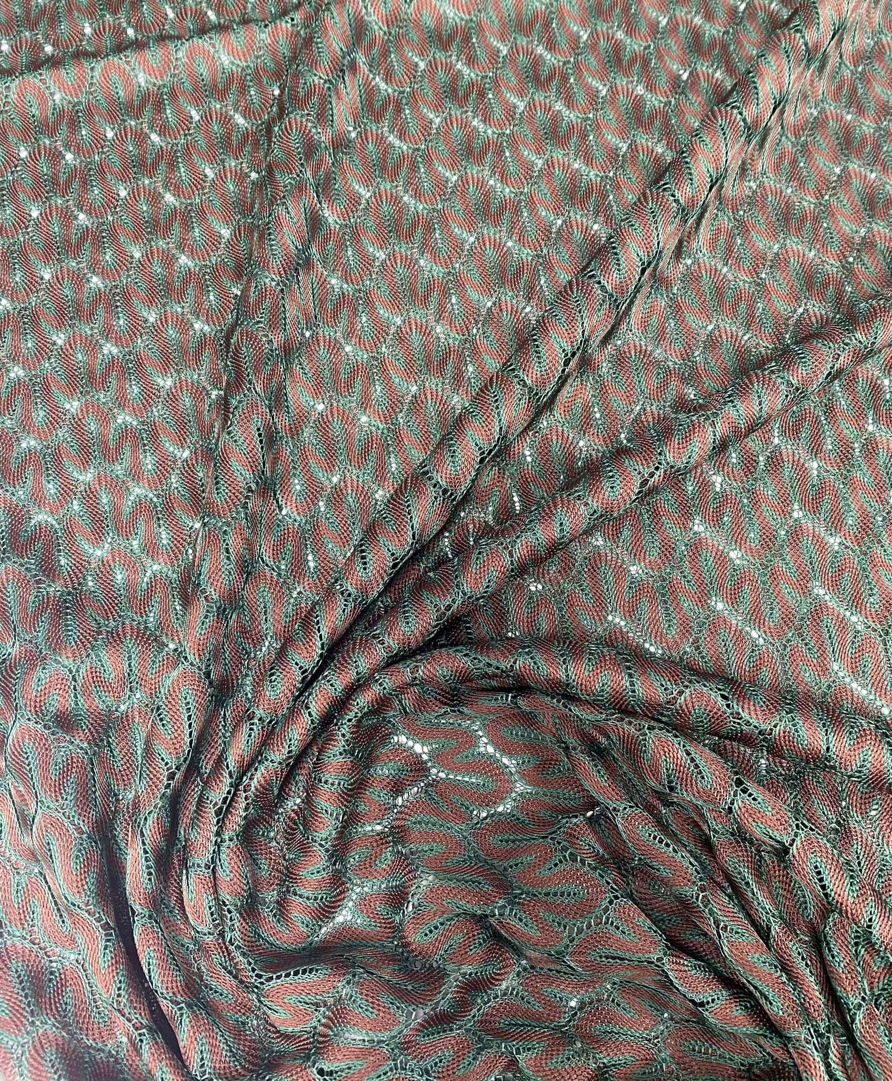 Green-brown woven mesh fabric with intricate texture for crafting and upholstery projects