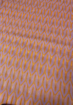 Zigzag knit jersey mesh fabric in lilac with orange zigzag pattern, lightweight and breathable textile for apparel and crafts
