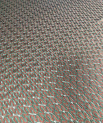 Green-brown woven mesh fabric with intricate texture for crafting and upholstery projects