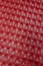 Close-up of red zigzag knit jersey fabric with soft stretchy texture for apparel and crafts