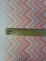 Red and white chevron fabric with ruler showing fabric width for sewing and crafting projects