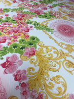 Orchid swirl print fabric with pink floral and green leaves pattern on white background with gold decorative swirls