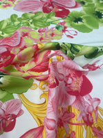 Orchid swirl print fabric with pink and green floral pattern on white background, ideal for sewing and crafts