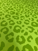neon green leopard print fabric with bold animal pattern in vibrant green tones