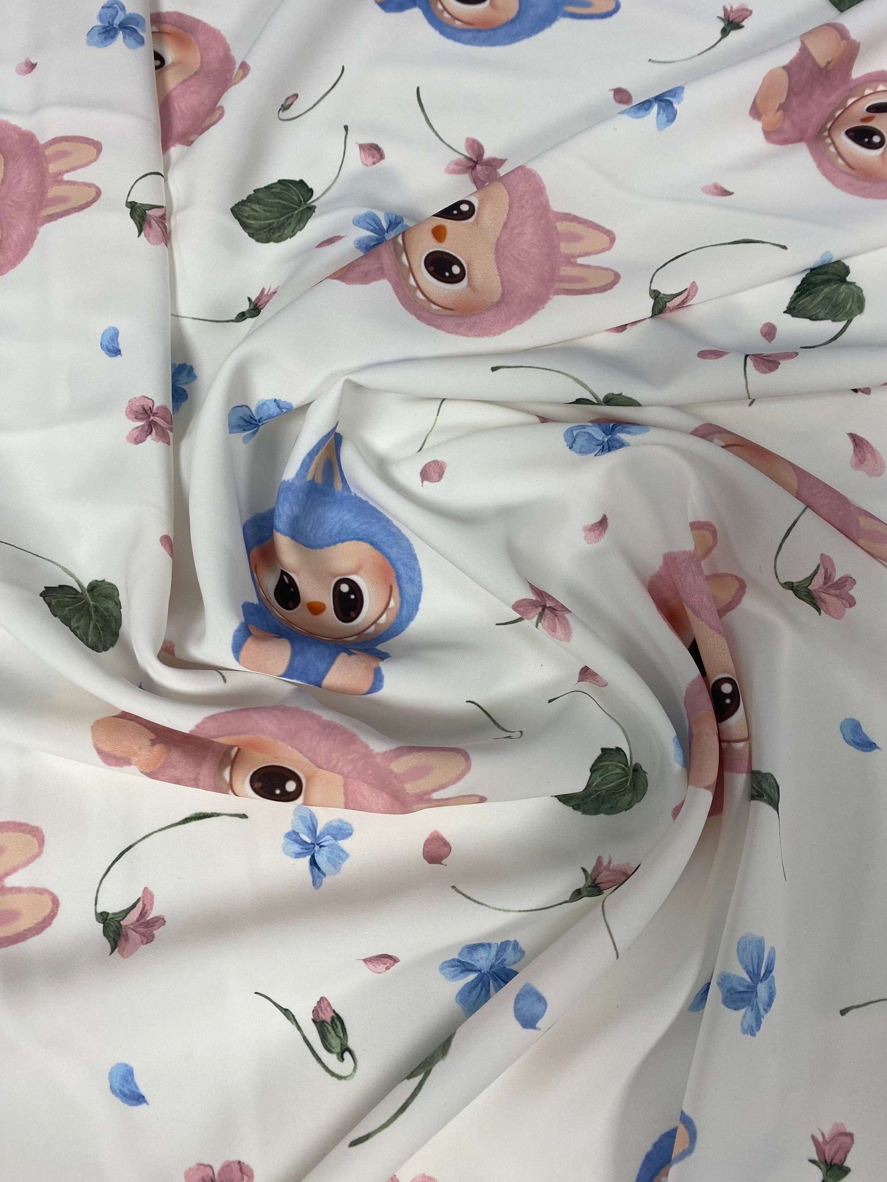 White fabric with cute cartoon animal prints and small floral accents