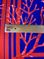 Red coral pattern fabric panel with navy blue background and ruler for scale