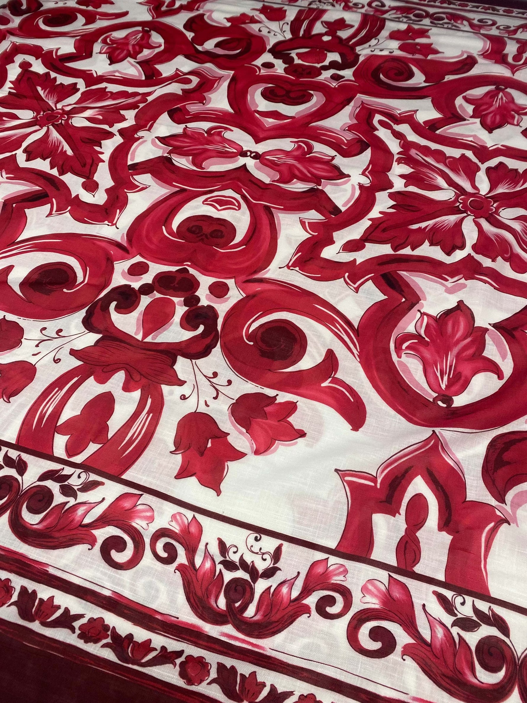 Red Baroque pattern linen fabric with intricate red floral and ornamental designs on white background for upholstery and crafts