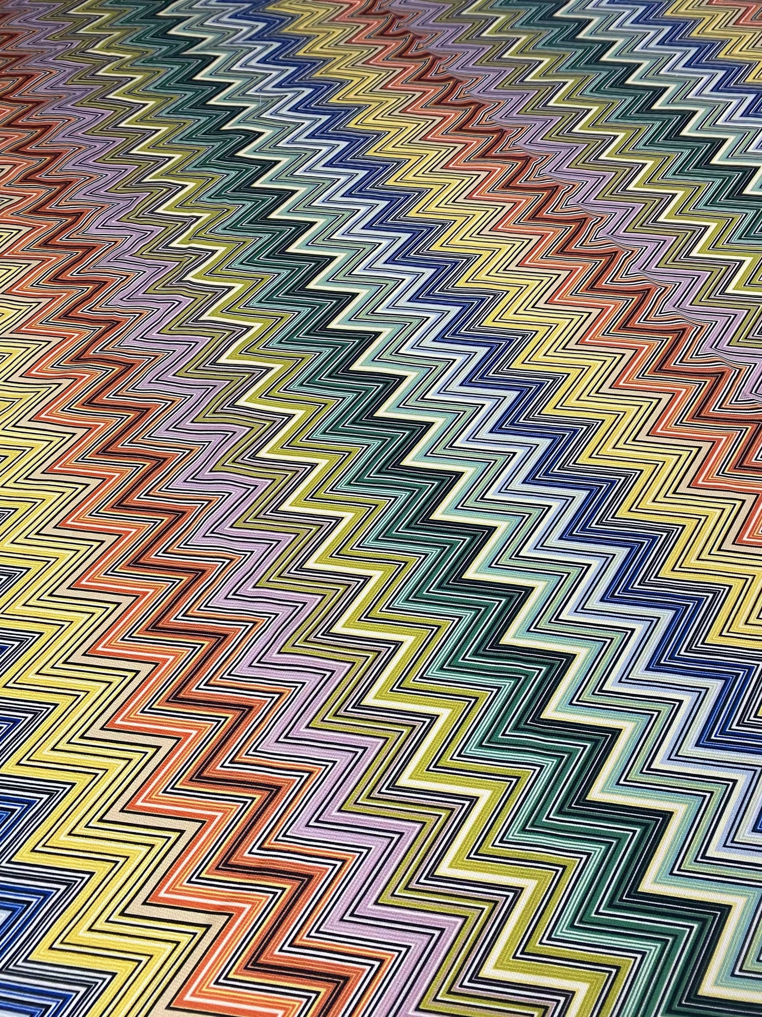 Colorful zigzag pattern upholstery fabric with vibrant multicolor chevron design on durable polyester material
