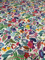 colorful floral design upholstery fabric with vibrant flowers and leaves pattern on white background