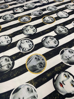 artistic portrait upholstery fabric with black and white striped background and various vintage-style faces in circles for unique home décor