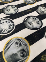 Artistic portrait upholstery fabric featuring vintage black and white faces on a striped background for unique home décor