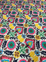 Colorful floral upholstery fabric with vibrant blossoms and intricate patterns for home décor and crafts