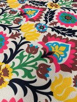 Colorful floral upholstery fabric with vibrant blossoms and intricate patterns for home décor and crafts