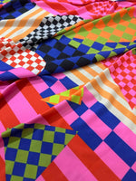 Multicolor abstract geometric fabric with vibrant checkerboard and stripe patterns in various bright colors and 150cm width