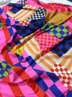 Multicolor abstract geometric fabric with vibrant checkered and striped patterns in various colors and 150cm width