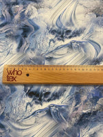 close up of abstract marble effect fabric with blue and white swirls and a wooden ruler showing scale