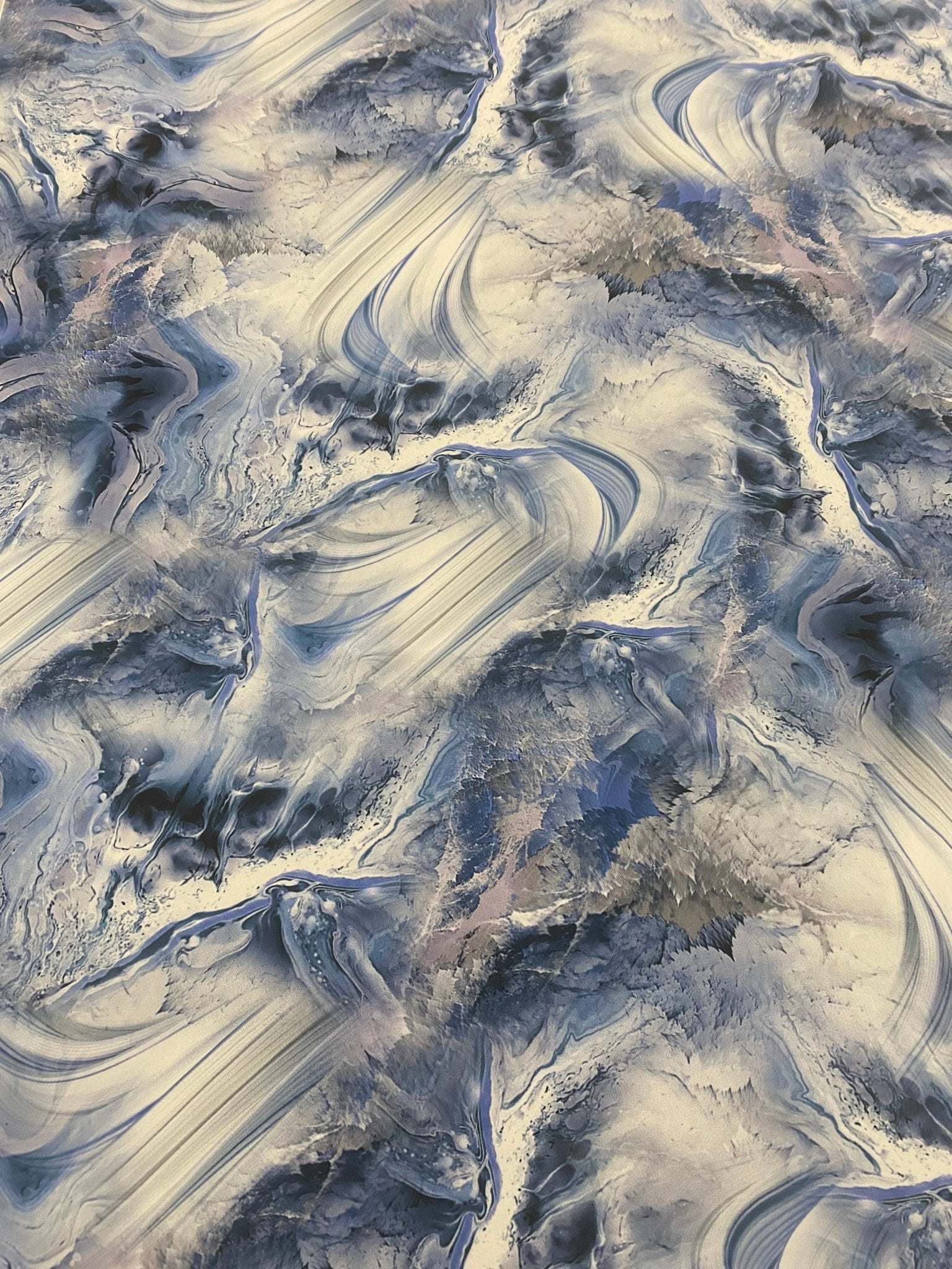 Abstract marble effect fabric with swirling blue, grey, and beige patterns, 150cm wide, ideal for upholstery and crafts