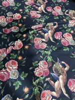 Angel Floral Print Fabric with cherubs and pink roses on black background, 150cm wide textile for sewing and crafting projects