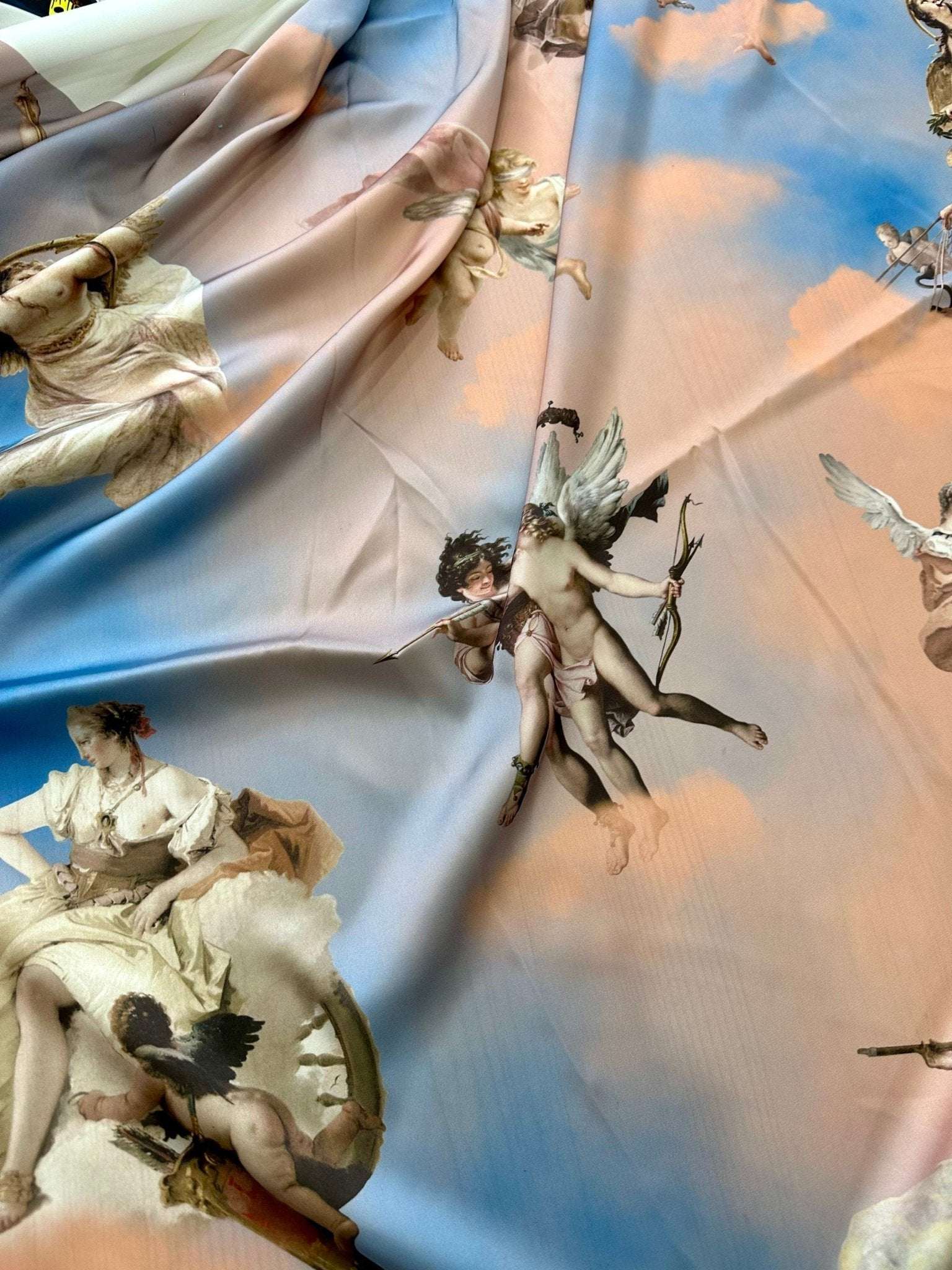 Angel print sky blue fabric with whimsical cherubs and soft cloud patterns for crafting and décor