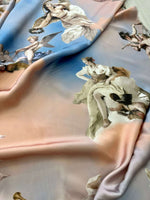 Angel print sky blue fabric with soft texture and whimsical cloud pattern for crafting and home décor