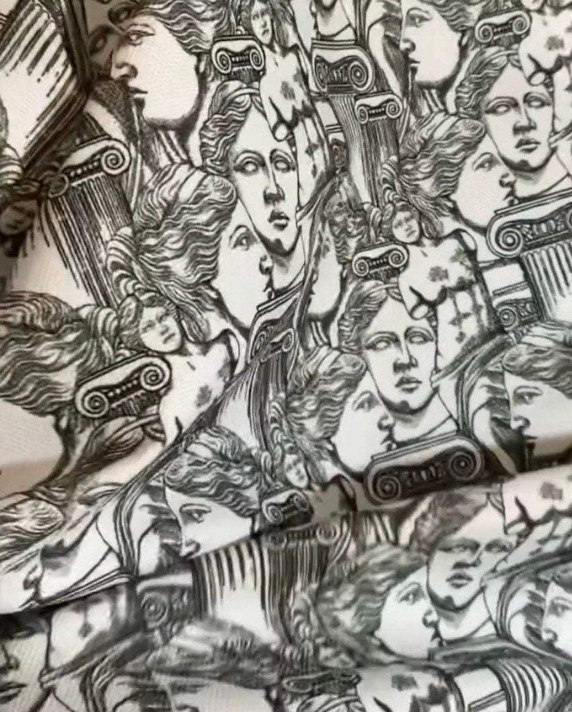 Antik Greek Print Fabric featuring intricate classical Greek faces and architectural elements in black and white design
