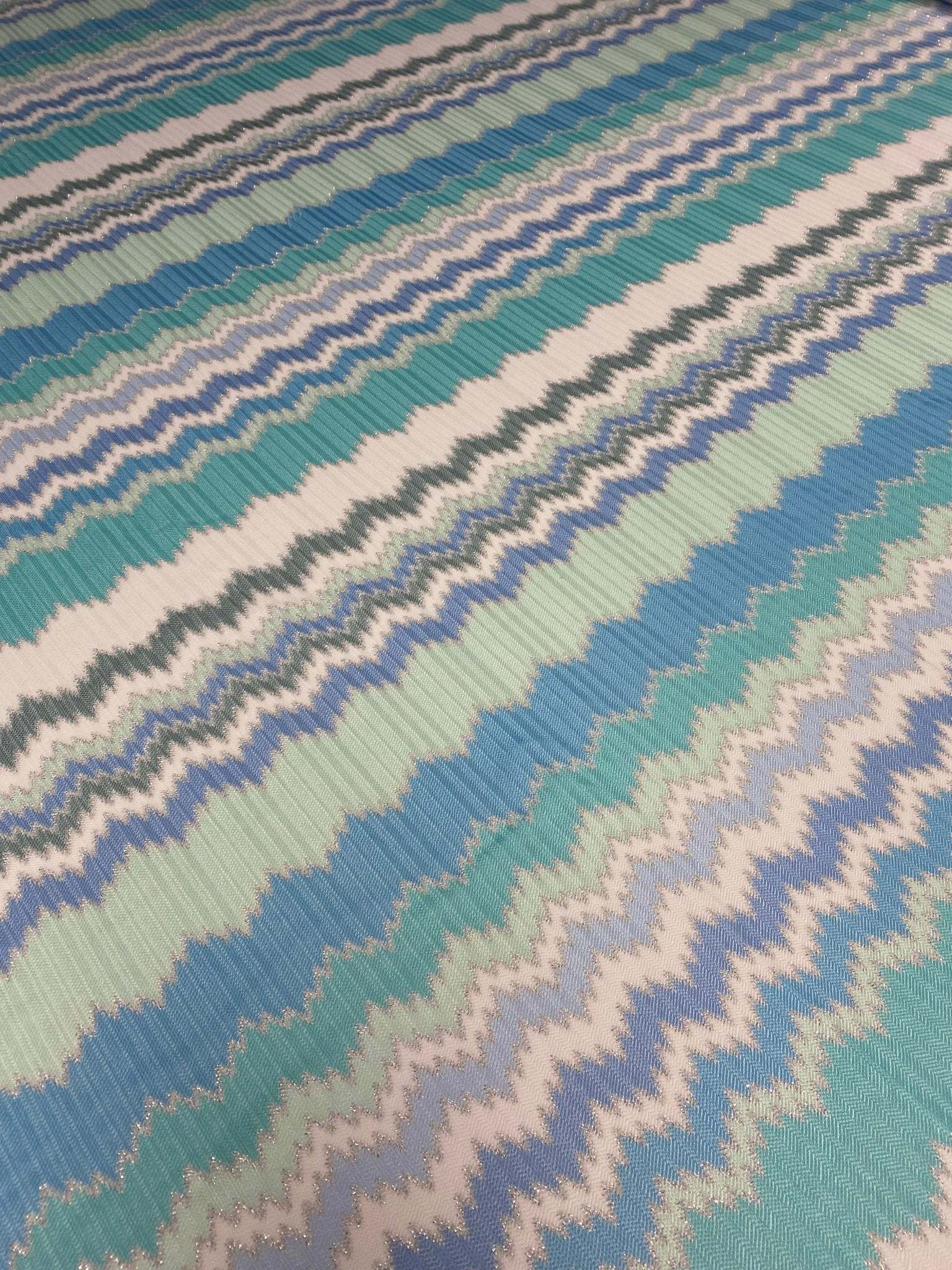 Aqua blue and mint green zigzag pattern woven knit fabric with textured stripes for fashion sewing projects