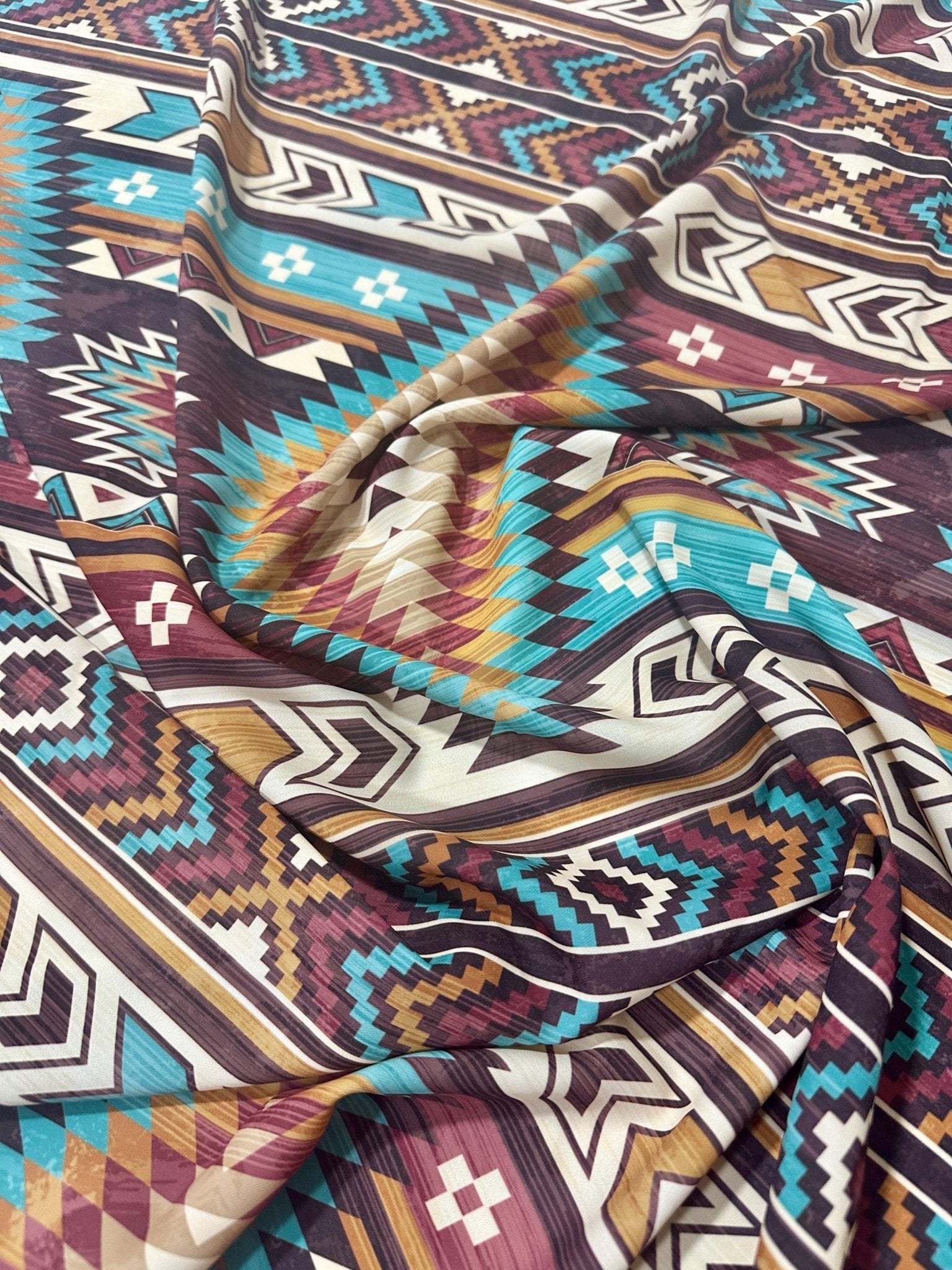 Aztec Retro Southwest Fabric with vibrant geometric patterns in turquoise, brown, maroon, and beige, ideal for sewing and crafting projects.