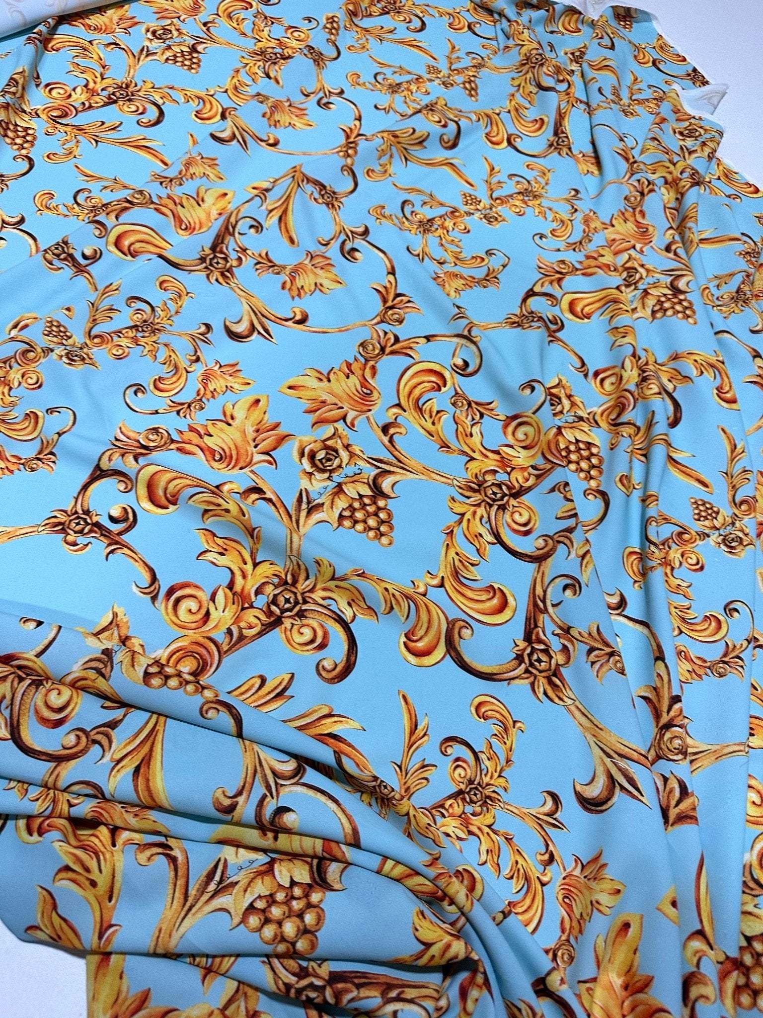 Baby blue baroque print fabric with gold ornate floral and scroll designs, soft texture, 150cm width