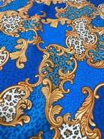 Blue Baroque leopard print fabric with gold ornamental swirls and animal print details