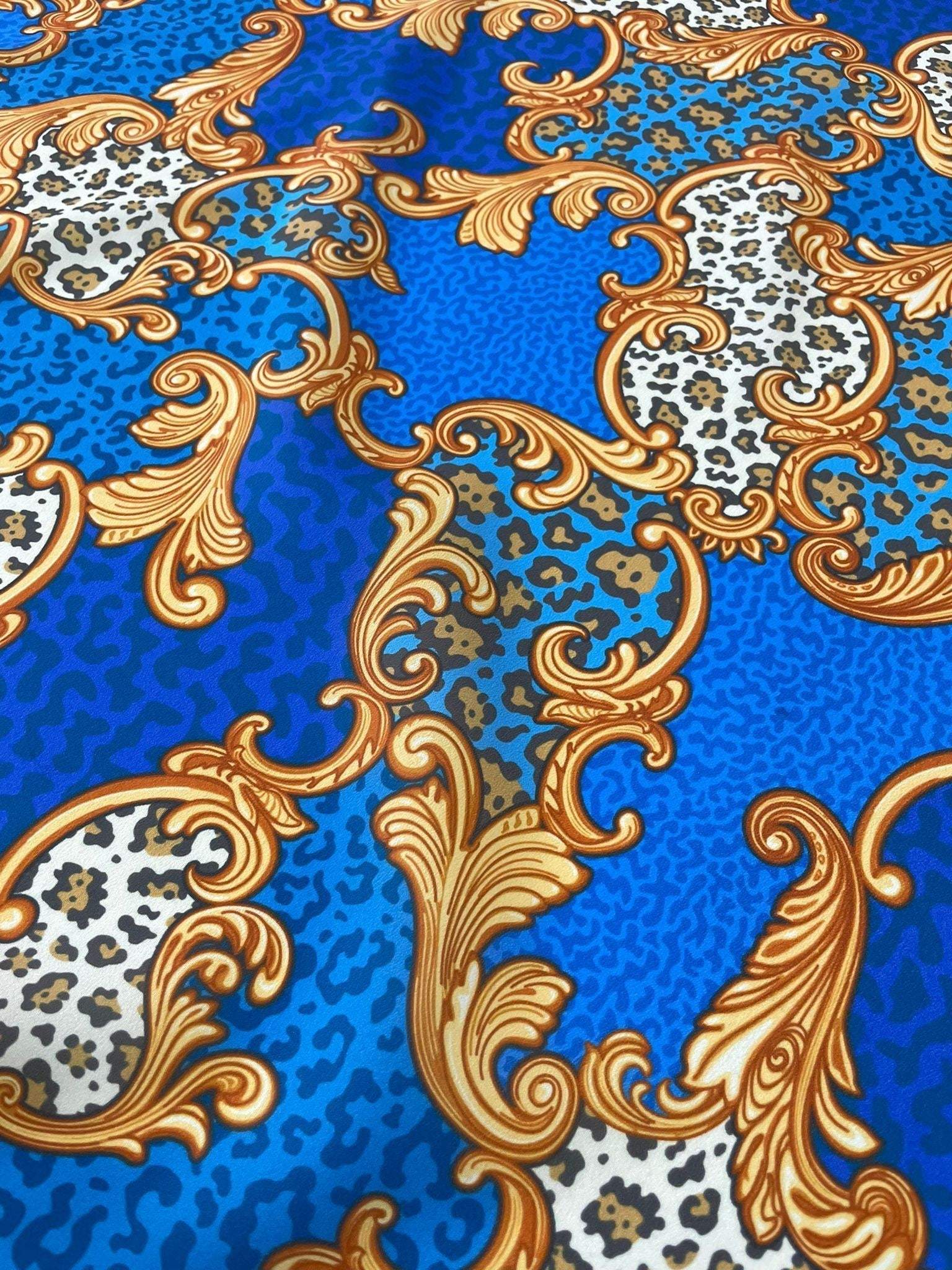 Blue Baroque leopard print fabric with gold ornamental swirls and animal print details