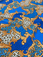 Baroque leopard print fabric with blue background and ornate gold scroll designs