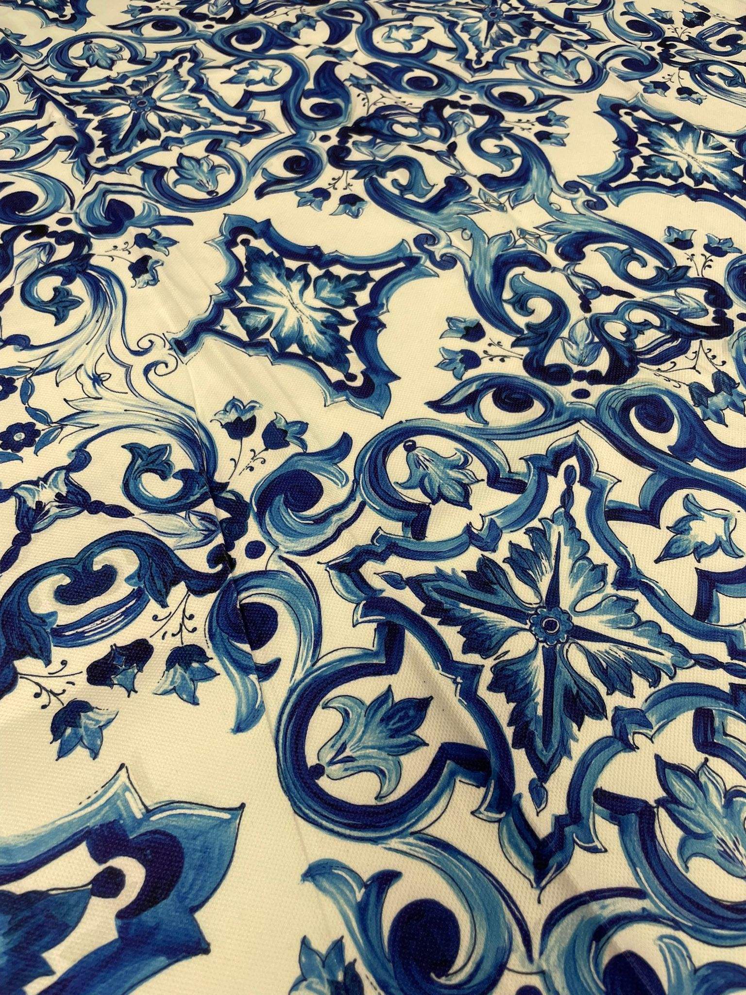 Baroque design upholstery fabric with intricate blue floral and scroll patterns on a cream background for elegant home décor