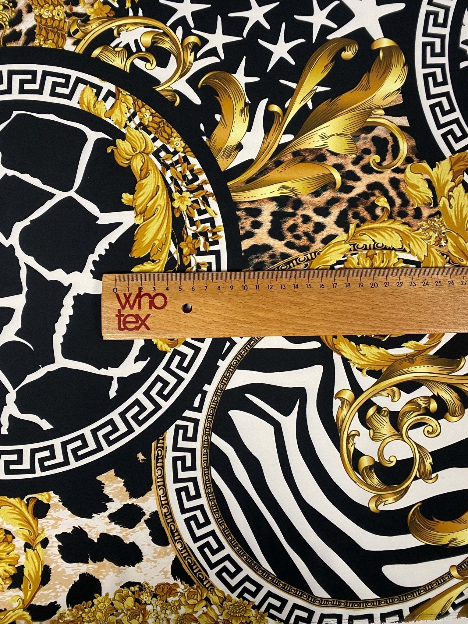 Baroque Greek Key Fabric with ornate gold baroque and animal print patterns on black and white background