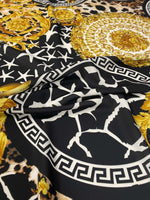 Baroque Greek key fabric with black, white, and gold ornate pattern and intricate design details