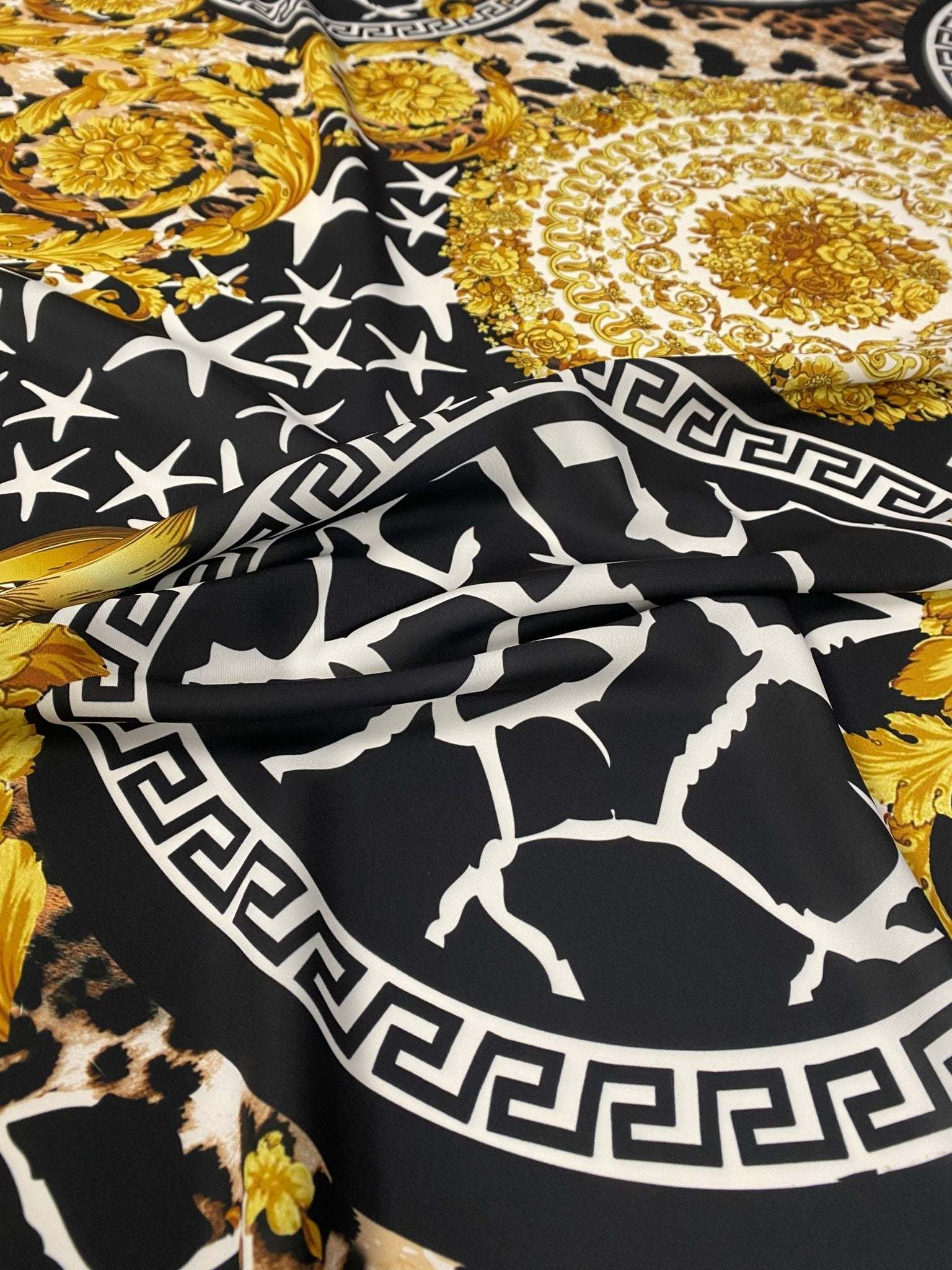 Baroque Greek key fabric with black, white, and gold ornate pattern and intricate design details