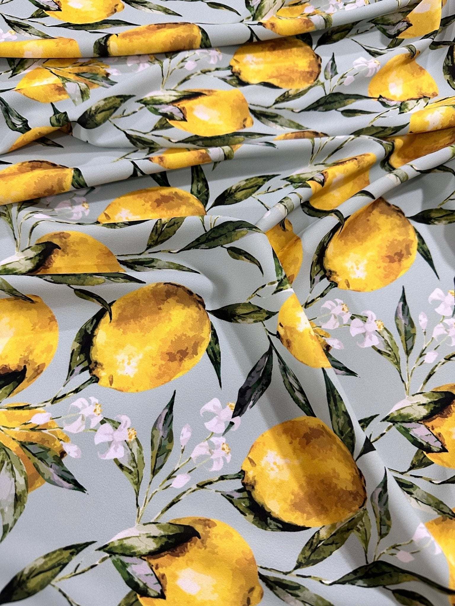Baroque Lemon Fabric with vibrant yellow lemons and green leaves on a light background, perfect for elegant sewing projects