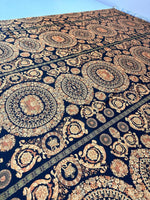 Baroque black and gold fabric with intricate circular and floral patterns for upholstery and fashion projects