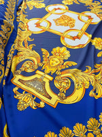 Baroque gold pattern fabric on royal blue background with intricate ornate designs for upholstery and drapery