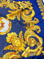 Baroque gold pattern fabric on royal blue background with intricate ornate designs and cherubic motifs