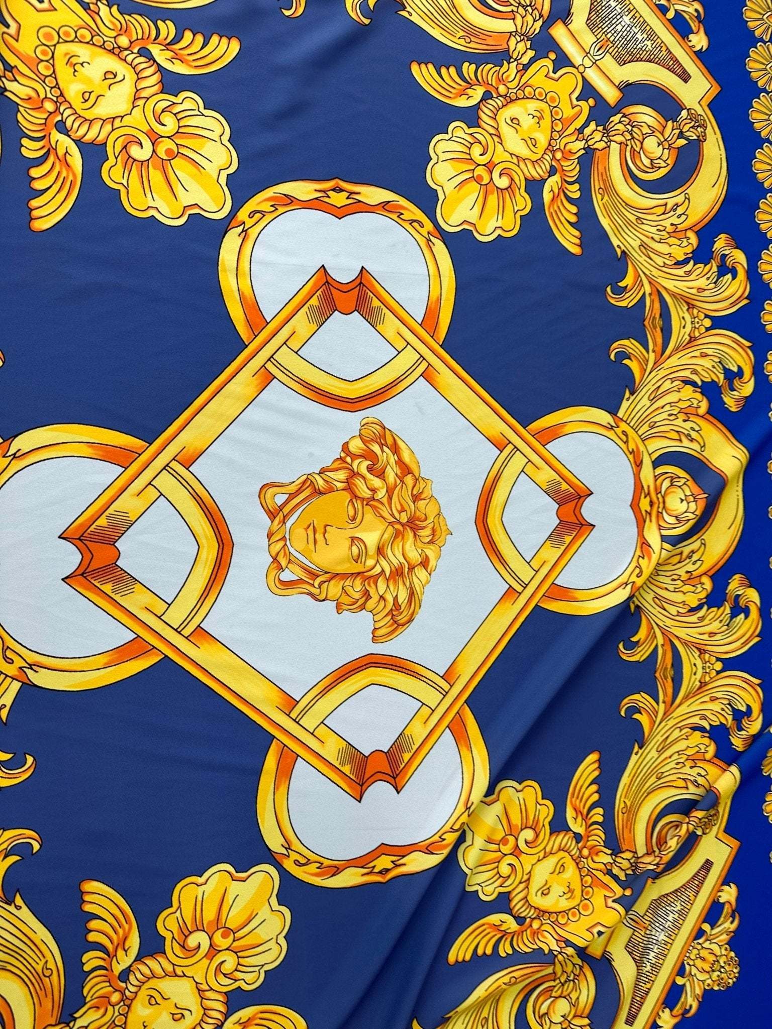 Baroque gold pattern fabric with intricate gold designs on royal blue background, ideal for upholstery and drapery.