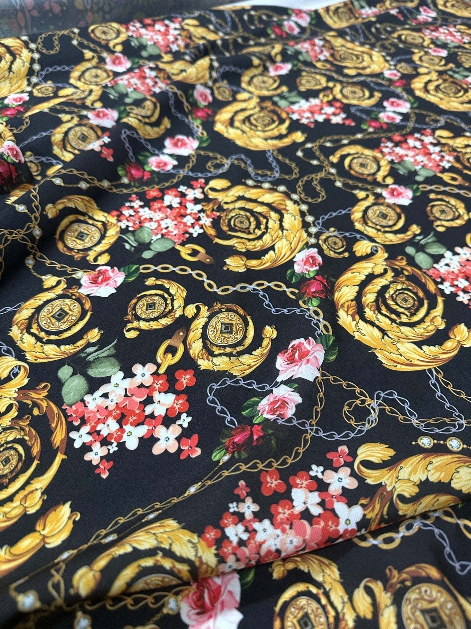 Baroque floral chain fabric with gold ornate patterns and pink flowers on black background