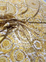 Baroque gold and white fabric with intricate floral and ornate pattern, luxurious material for upholstery and drapery projects