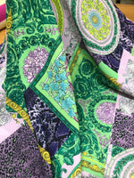 Baroque pattern fabric with green borders and soft pastel colors featuring intricate floral and ornamental designs