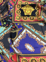 Baroque patchwork fabric with intricate gold, red, blue, and black decorative patterns and medallions