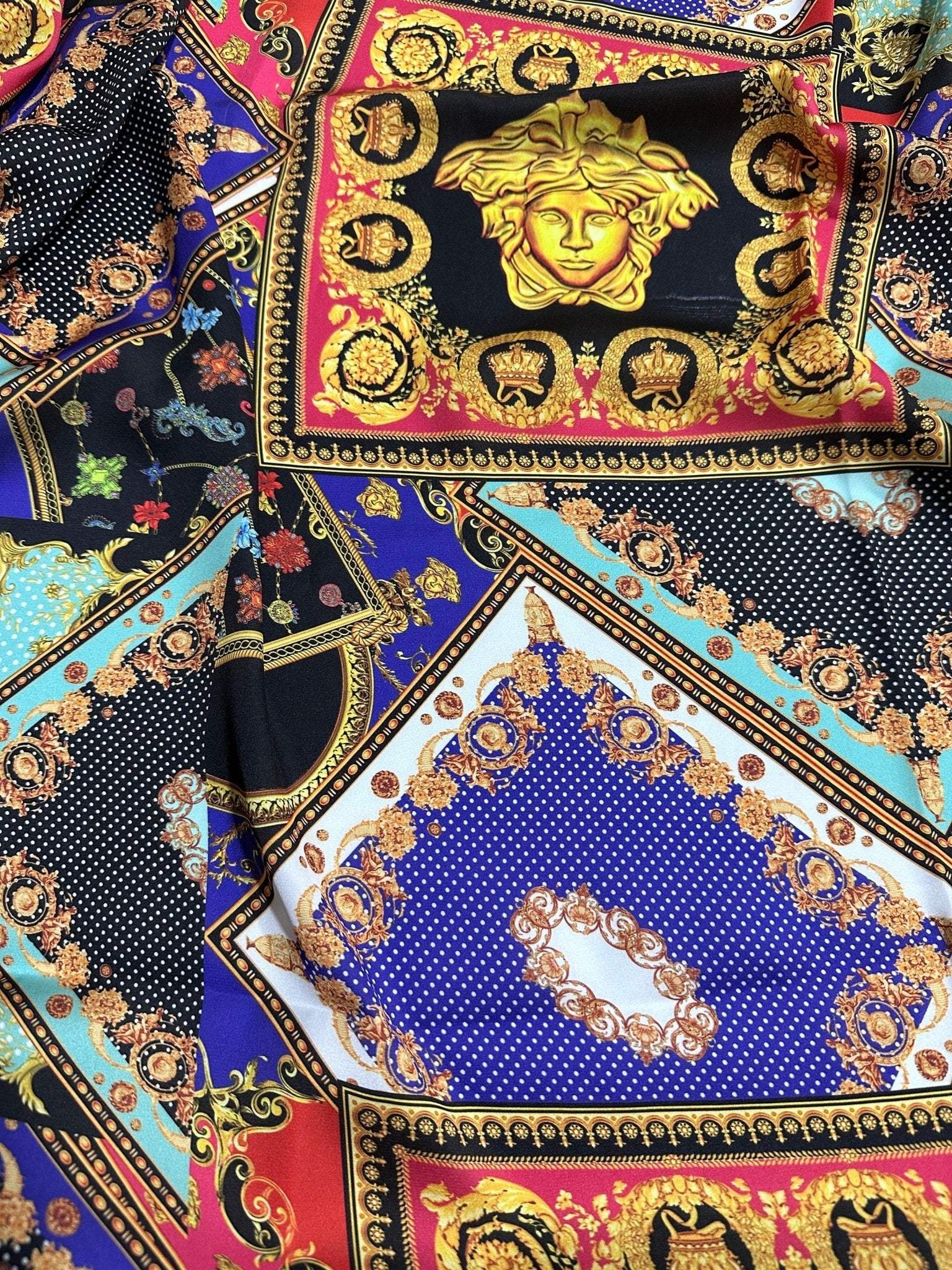 Baroque patchwork fabric with intricate gold, red, blue, and black decorative patterns and medallions