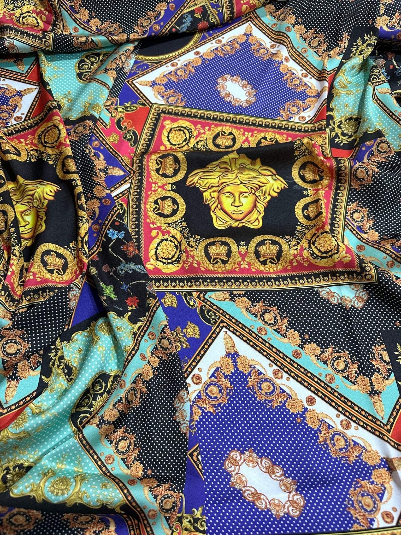 Baroque patchwork fabric with intricate gold, blue, turquoise, and black decorative patterns and medallion motifs