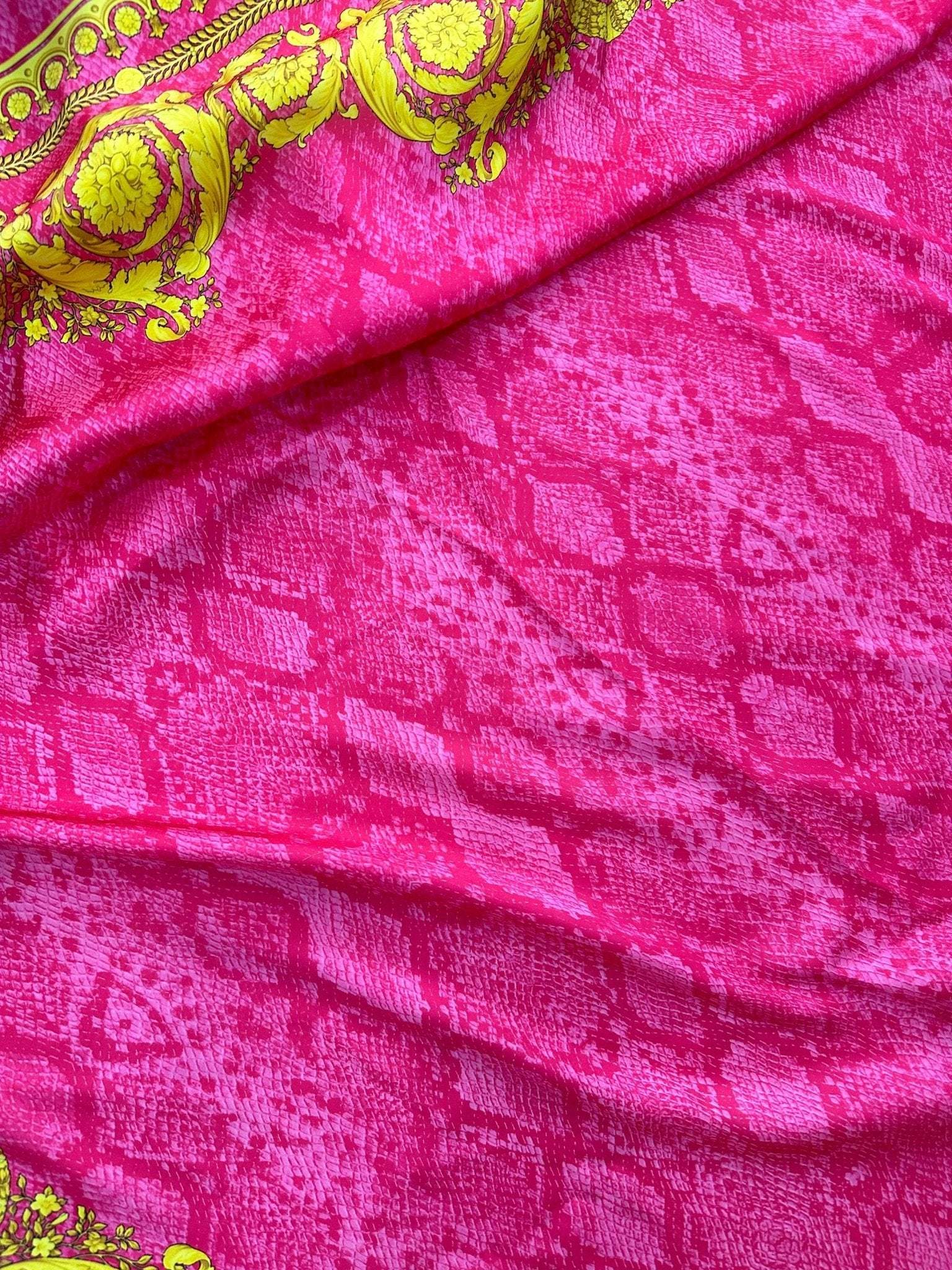 Baroque pink satin fabric with intricate yellow baroque patterns and a soft sheen texture
