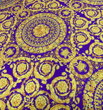 Purple Baroque pattern fabric with intricate gold floral and ornamental designs on a rich purple background, suitable for upholstery and drapery.