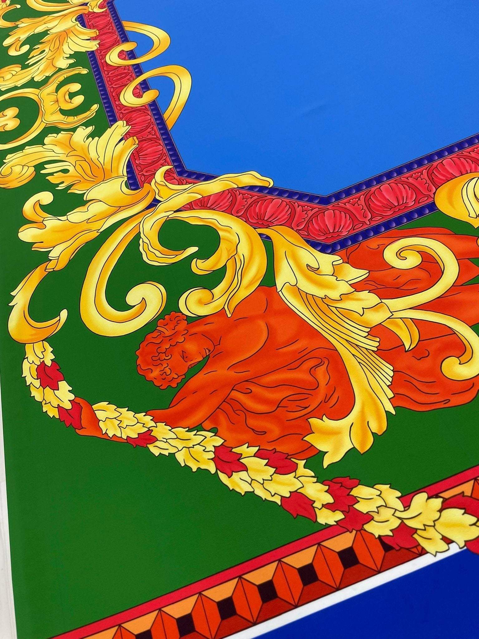 Baroque silky crepe fabric with ornate gold, red, and green baroque pattern on a blue background