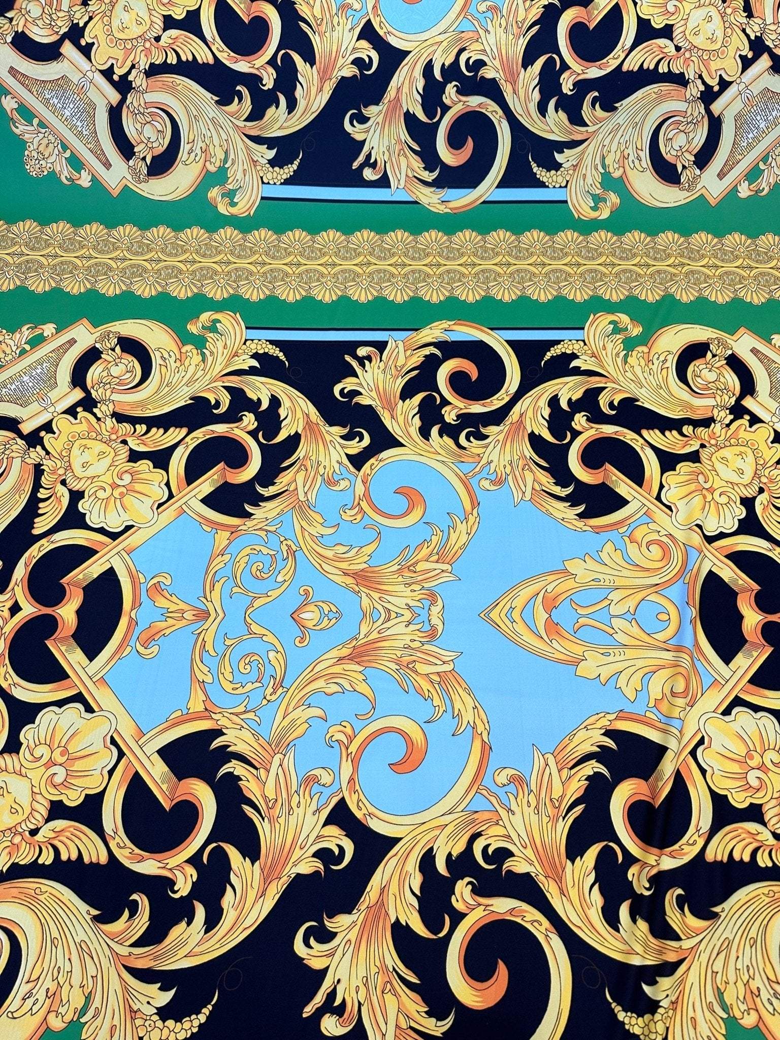Baroque silky crepe fabric with intricate gold and blue baroque patterns on black background